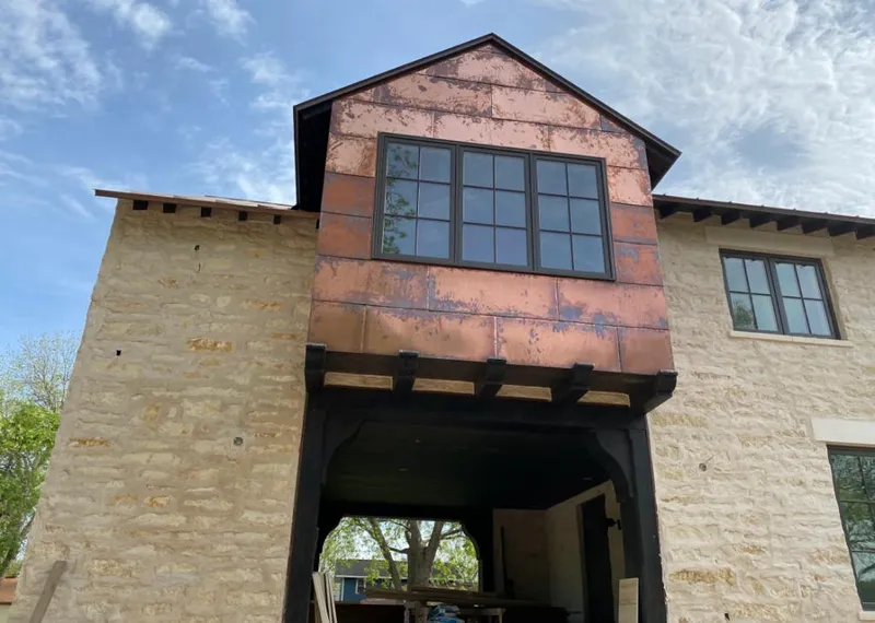 Copper metal panel facade on a stone building for Skylight Installation in St. Helena